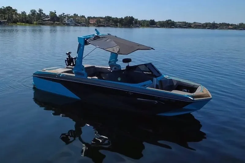 Slide: The Image of 2022 Nautique Super Air Nautique G23 boat on calm lake waters. - 113