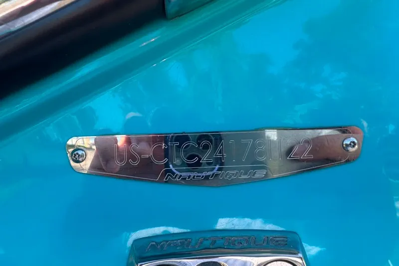 Slide: The Image of 2022 Nautique Super Air Nautique G23 hull identification plate on blue surface. - 19
