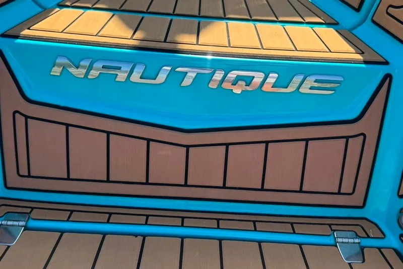 Slide: The Image of 2022 Nautique Super Air Nautique G23 boat deck with logo in blue and brown. - 34