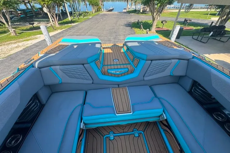 Slide: The Image of 2022 Nautique Super Air Nautique G23 boat interior with blue and gray seating. - 105