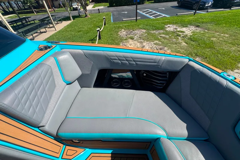 Slide: The Image of Interior seating of 2022 Nautique Super Air Nautique G23 boat, featuring gray and teal upholstery. - 46