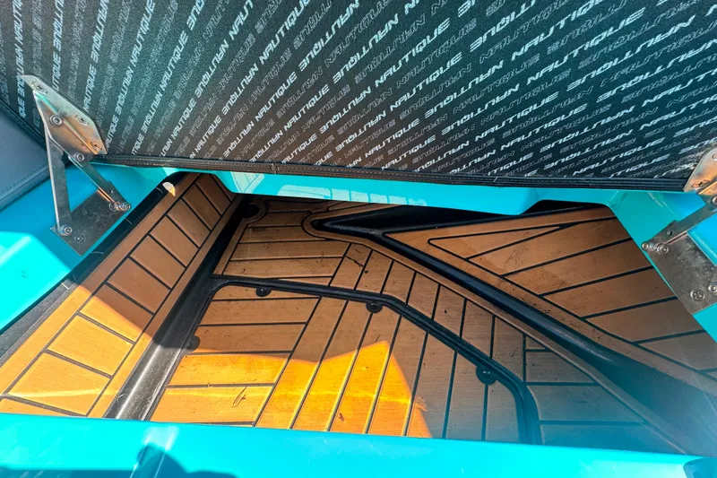 Slide: The Image of 2022 Nautique Super Air Nautique G23 interior storage compartment with teak flooring. - 107