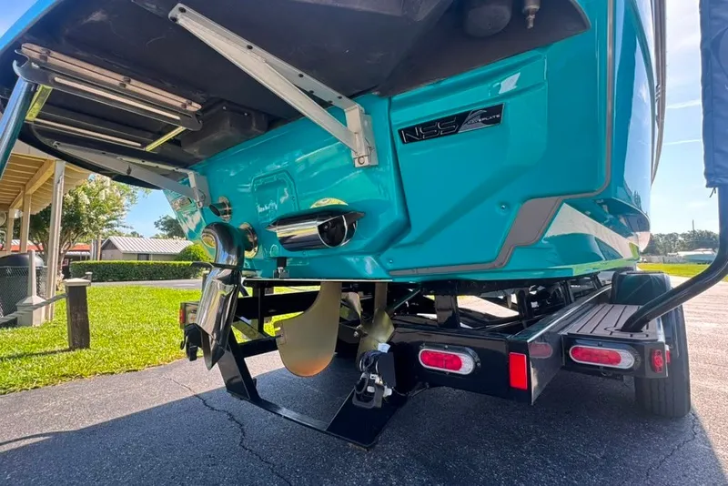 Slide: The Image of 2022 Nautique Super Air Nautique G23 boat on trailer, showcasing rear design and propeller. - 18