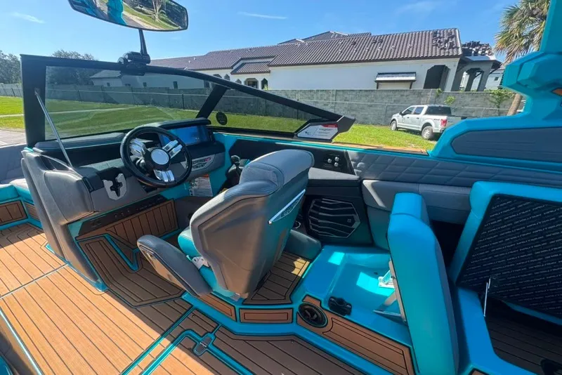Slide: The Image of 2022 Nautique Super Air Nautique G23 boat interior with modern dashboard and seating. - 58