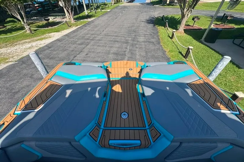 Slide: The Image of 2022 Nautique Super Air Nautique G23 boat interior with teak and turquoise accents. - 115