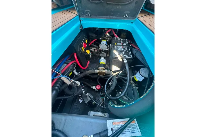 Slide: The Image of Engine compartment of 2022 Nautique Super Air Nautique G23 with visible wiring and components. - 70
