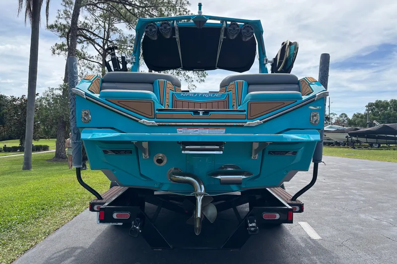 Slide: The Image of 2022 Nautique Super Air Nautique G23 boat, rear view, vibrant blue color. - 16