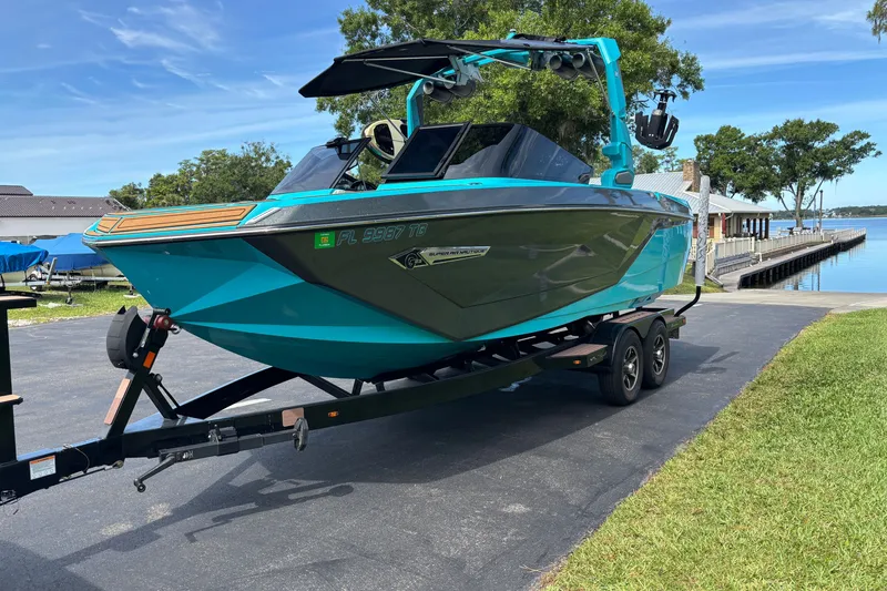 Slide: The Image of 2022 Nautique Super Air Nautique G23 boat on trailer by a lakeside dock. - 9