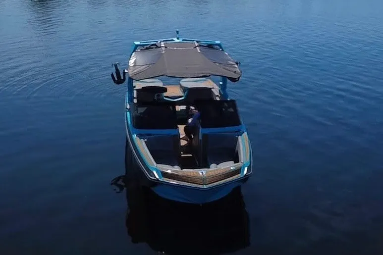 Slide: The Image of 2022 Nautique Super Air Nautique G23 boat on calm water, aerial view. - 86