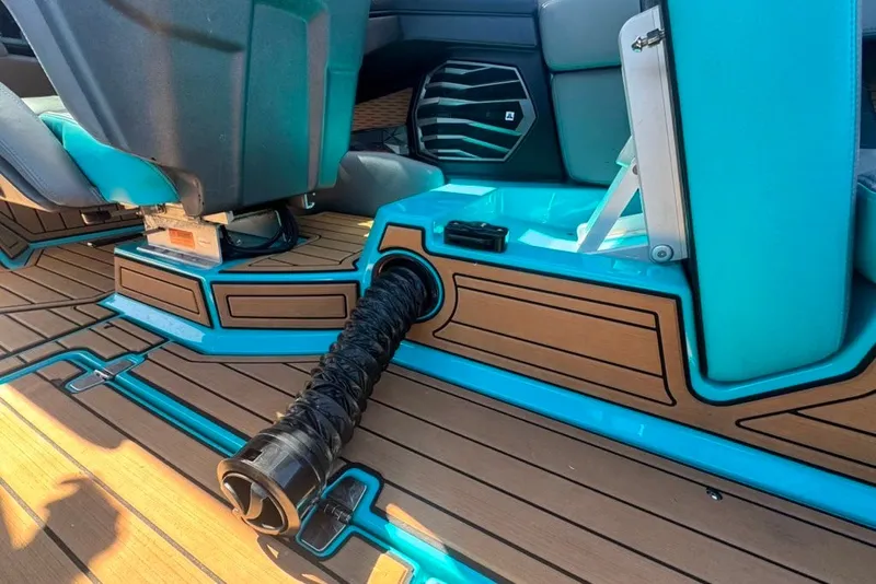 Slide: The Image of Interior of 2022 Nautique Super Air Nautique G23 boat with teal and wood accents. - 100