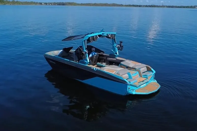Slide: The Image of 2022 Nautique Super Air Nautique G23 boat on calm blue water. - 39
