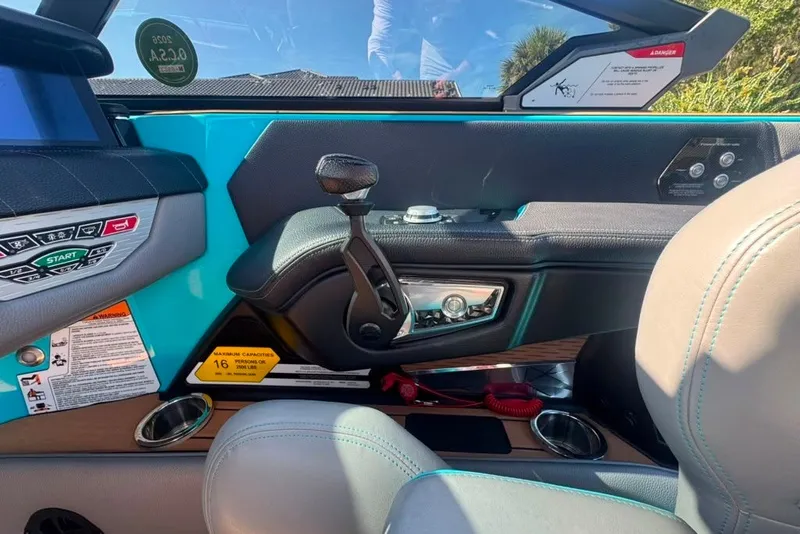 Slide: The Image of Interior of 2022 Nautique Super Air Nautique G23 boat, featuring control panel and seating. - 120