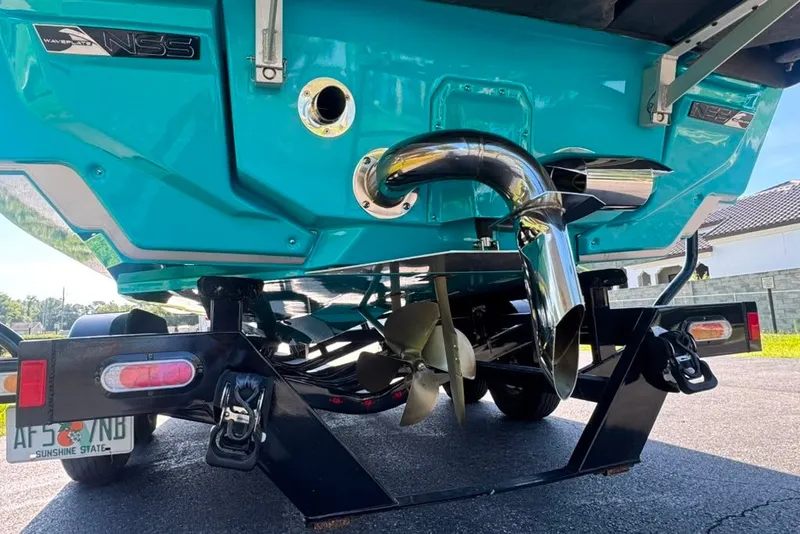 Slide: The Image of 2022 Nautique Super Air Nautique G23 boat rear view, showcasing propeller and exhaust system. - 17