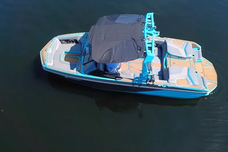 Slide: The Image of 2022 Nautique Super Air Nautique G23 boat on calm water, featuring sleek design and modern amenities. - 97