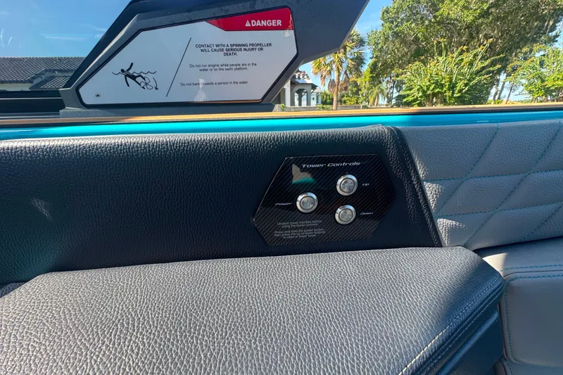 Slide: The Image of Interior of 2022 Nautique Super Air Nautique G23 with tower controls and safety warning. - 37