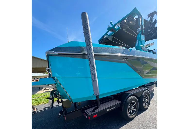 Slide: The Image of 2022 Nautique Super Air Nautique G23 boat in vibrant blue on a trailer. - 23