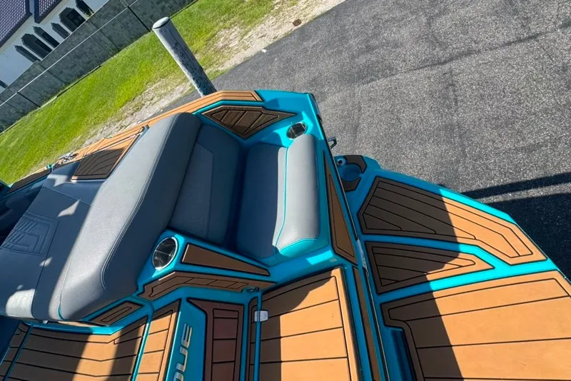 Slide: The Image of 2022 Nautique Super Air Nautique G23 boat interior with teal and wood accents. - 36