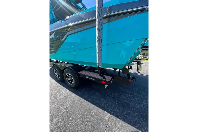 Slide: The Image of 2022 Nautique Super Air Nautique G23 boat on trailer, vibrant blue hull. - 112
