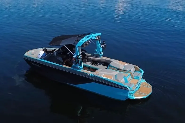 Slide: The Image of 2022 Nautique Super Air Nautique G23 boat on calm water, featuring sleek design and vibrant colors. - 73