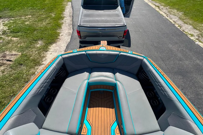 Slide: The Image of 2022 Nautique Super Air Nautique G23 boat hitched to a truck on a sunny day. - 67