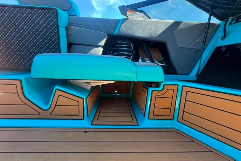 Slide: The Image of 2022 Nautique Super Air Nautique G23 interior with turquoise and wood accents. - 93