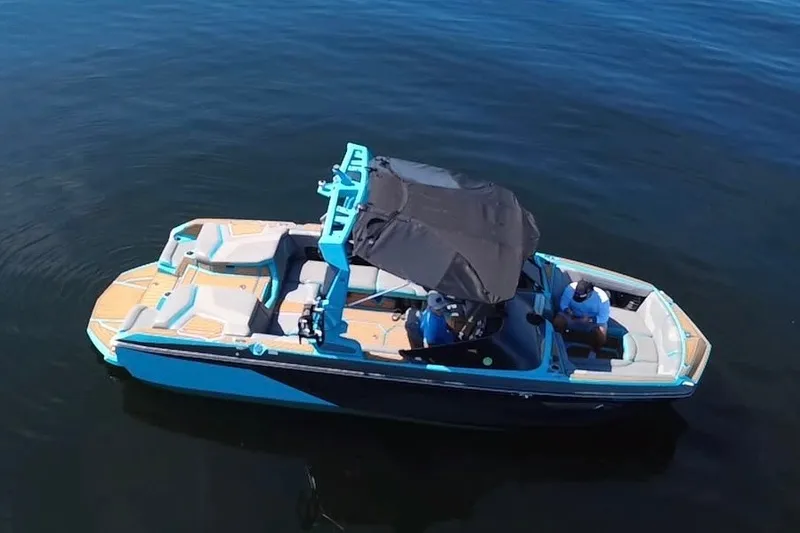 Slide: The Image of 2022 Nautique Super Air Nautique G23 boat on calm water, aerial view. - 108