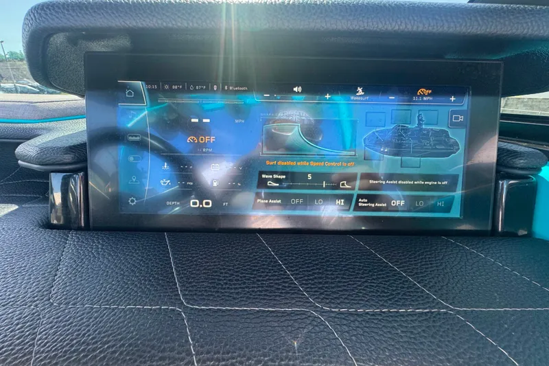 Slide: The Image of 2022 Nautique Super Air Nautique G23 dashboard display with touchscreen controls and navigation features. - 92