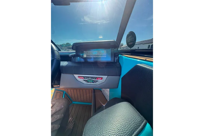 Slide: The Image of 2022 Nautique Super Air Nautique G23 dashboard with digital display and controls. - 57
