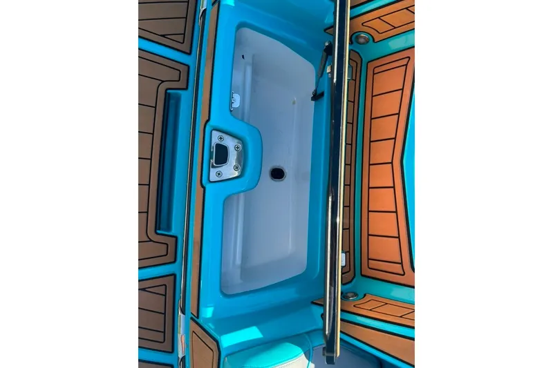 Slide: The Image of 2022 Nautique Super Air Nautique G23 boat interior with vibrant blue and brown accents. - 102
