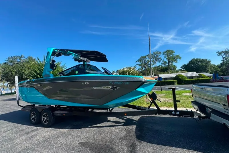 Slide: The Image of 2022 Nautique Super Air Nautique G23 boat on trailer, vibrant blue and gray design. - 53