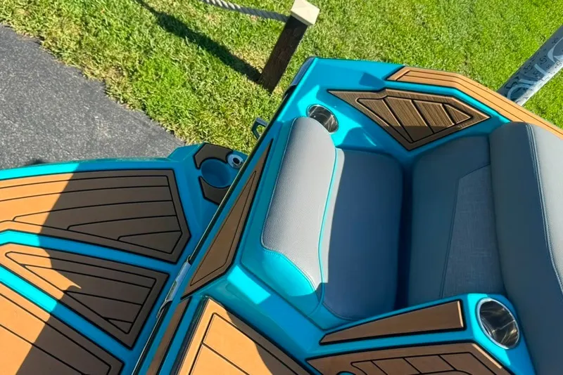 Slide: The Image of 2022 Nautique Super Air Nautique G23 boat interior with teal and wood accents. - 119