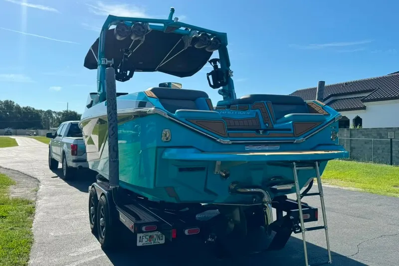 Slide: The Image of 2022 Nautique Super Air Nautique G23 boat on trailer, parked outdoors. - 13