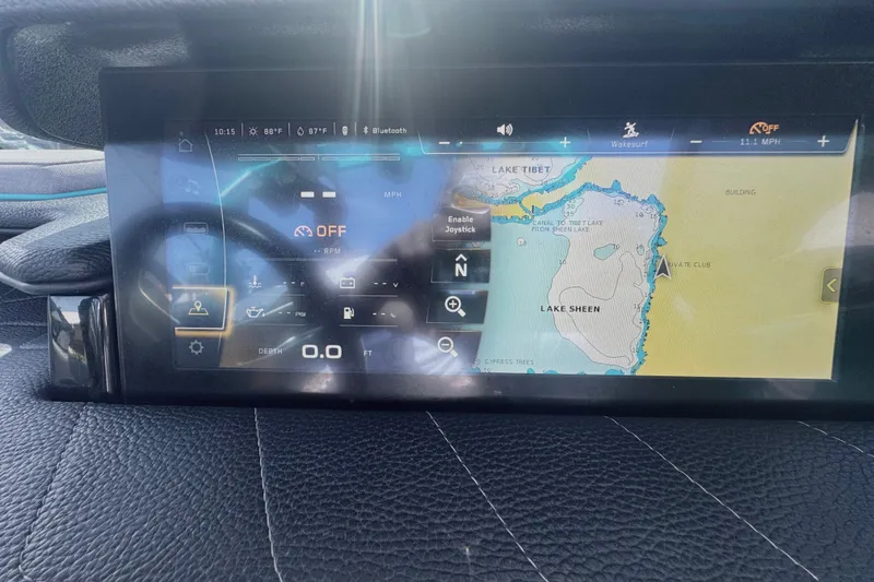 Slide: The Image of 2022 Nautique Super Air Nautique G23 dashboard with navigation display showing Lake Sheen map. - 60
