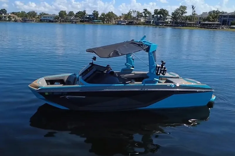 Slide: The Image of 2022 Nautique Super Air Nautique G23 boat on a calm lake. - 68