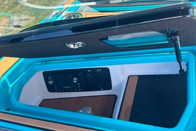 Slide: The Image of 2022 Nautique Super Air Nautique G23 storage compartment with audio controls. - 87