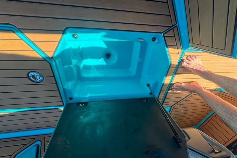 Slide: The Image of 2022 Nautique Super Air Nautique G23 boat deck with open storage compartment. - 32