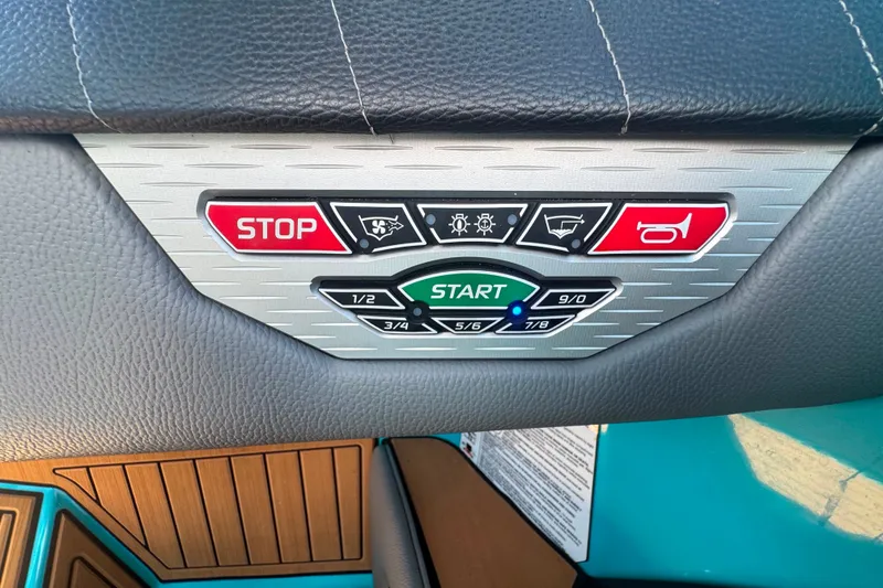 Slide: The Image of Control panel of 2022 Nautique Super Air Nautique G23 boat with start and stop buttons. - 91