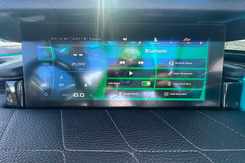 Slide: The Image of 2022 Nautique Super Air Nautique G23 dashboard display with Bluetooth and control options. - 84