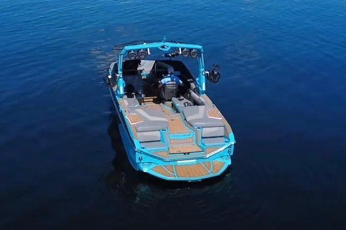 Slide: The Image of 2022 Nautique Super Air Nautique G23 boat on calm blue water. - 78