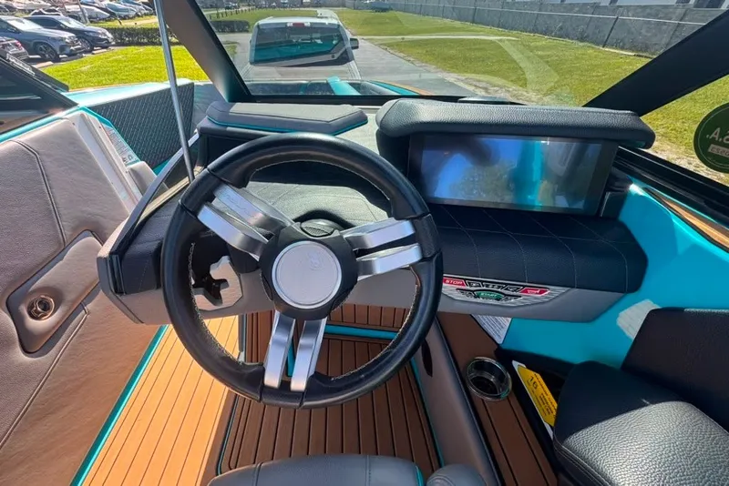 Slide: The Image of 2022 Nautique Super Air Nautique G23 dashboard with steering wheel and touchscreen display. - 121