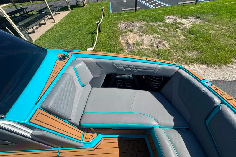 Slide: The Image of 2022 Nautique Super Air Nautique G23 boat interior with gray and turquoise seating. - 104