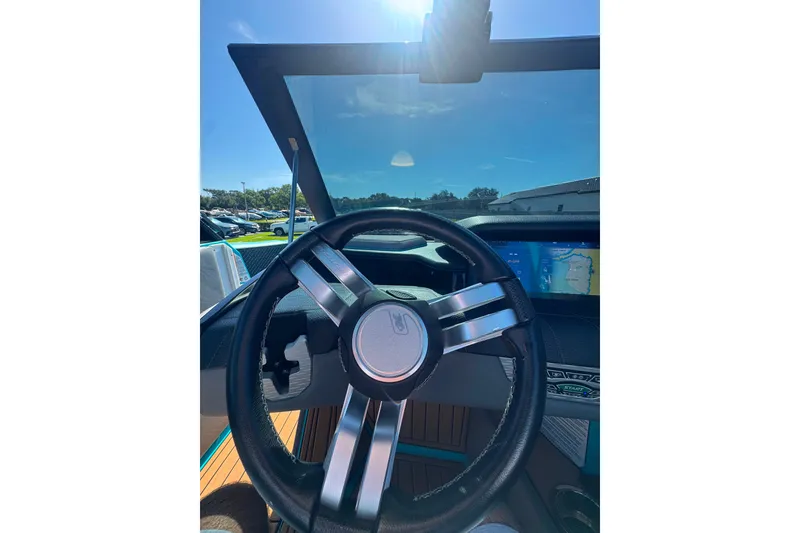 Slide: The Image of Steering wheel of 2022 Nautique Super Air Nautique G23 with dashboard display. - 76