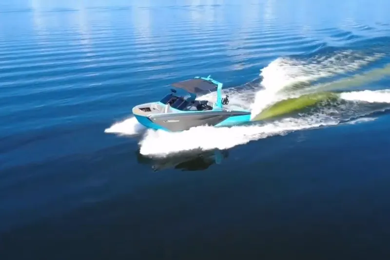 Slide: The Image of 2022 Nautique Super Air Nautique G23 cruising on a calm blue lake. - 123