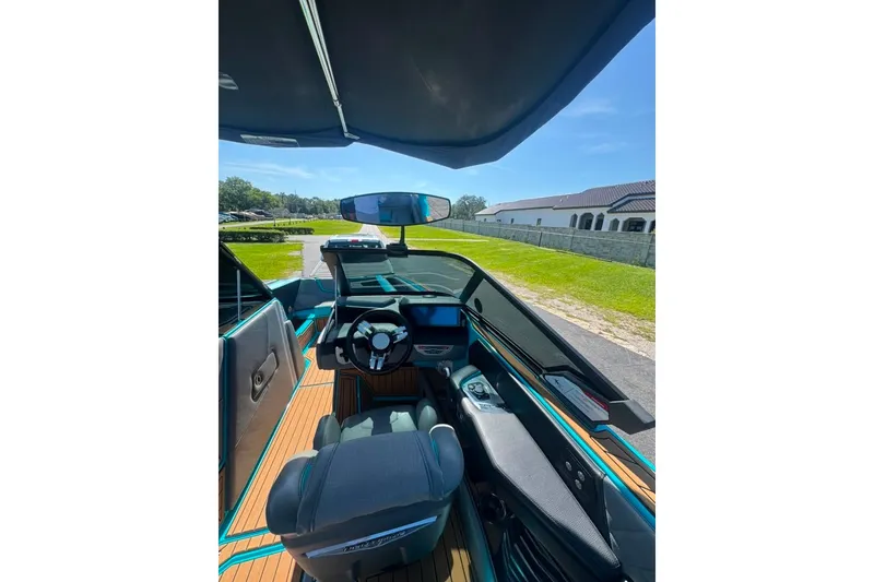Slide: The Image of Interior view of 2022 Nautique Super Air Nautique G23 boat, featuring sleek design and modern controls. - 88