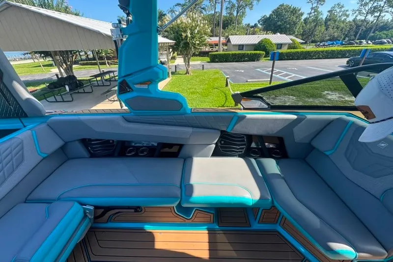 Slide: The Image of Interior of 2022 Nautique Super Air Nautique G23 boat with gray and teal seating. - 79