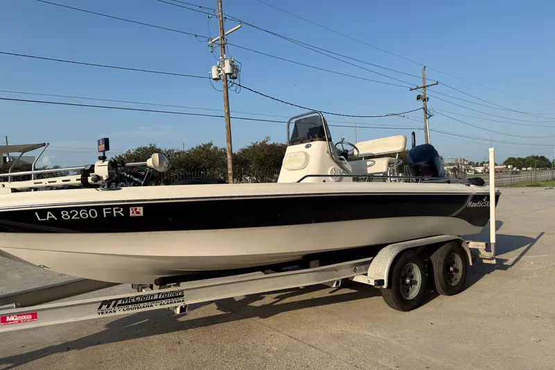 Slide: The Image of 2007 NauticStar 2200 NauticBay boat on trailer, parked outdoors under clear sky. - 5