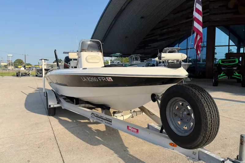 Slide: The Image of 2007 NauticStar 2200 NauticBay boat on trailer, parked outdoors near a building. - 3