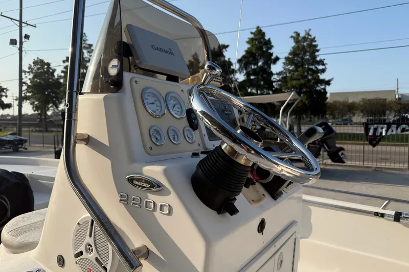 Slide: The Image of 2007 NauticStar 2200 NauticBay boat dashboard with steering wheel and gauges. - 13