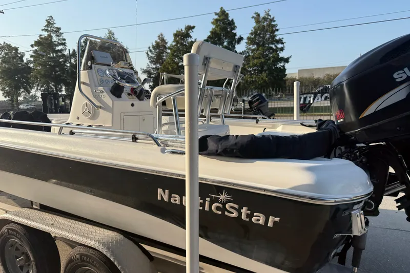 Slide: The Image of 2007 NauticStar 2200 NauticBay boat on trailer, featuring Suzuki outboard motor. - 8