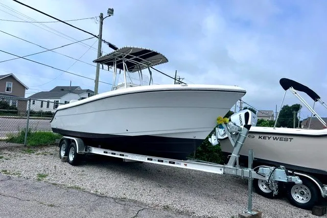 Slide: The Image of 2020 Cobia 237 Center Console boat on trailer, parked outdoors. - 1